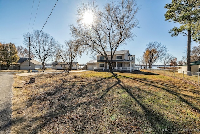 view of yard featuring covered porch and a water view