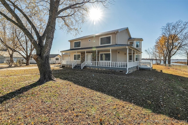 farmhouse-style home featuring a front yard and a porch