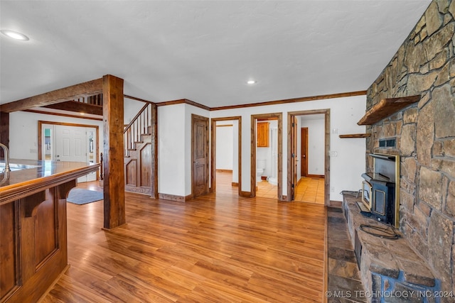 living room with sink, light hardwood / wood-style flooring, and ornamental molding