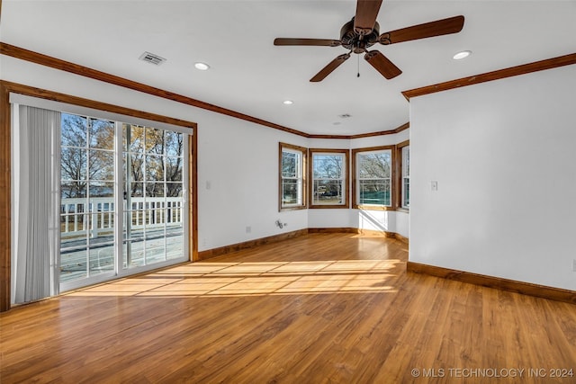 spare room featuring light hardwood / wood-style flooring, ceiling fan, and ornamental molding