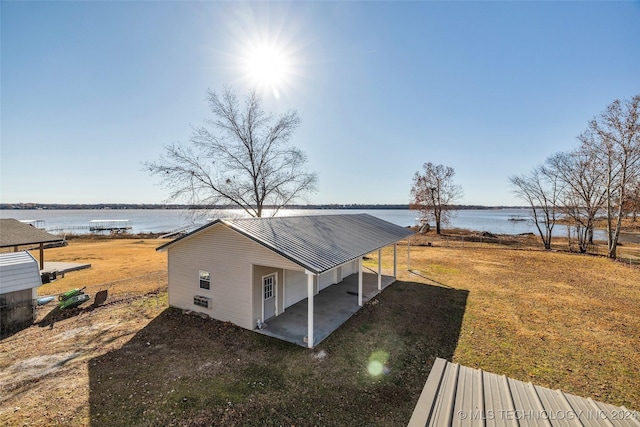 exterior space featuring a patio area and a water view