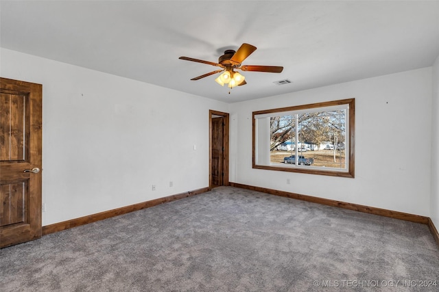 carpeted spare room featuring ceiling fan