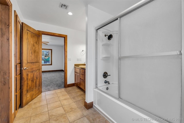 bathroom featuring vanity, tile patterned floors, and bath / shower combo with glass door