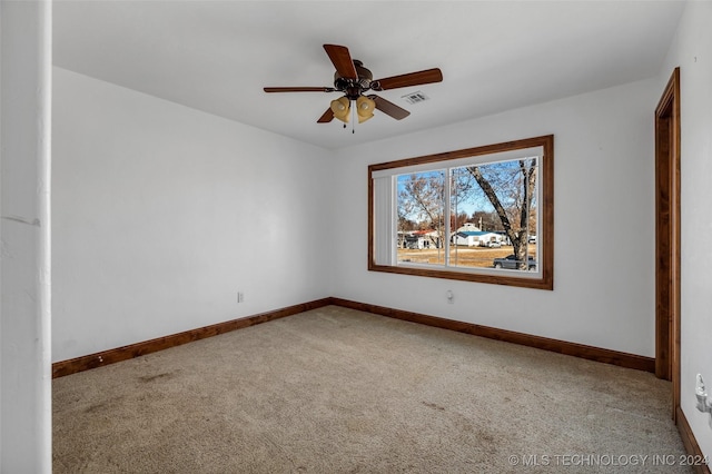 carpeted spare room with ceiling fan