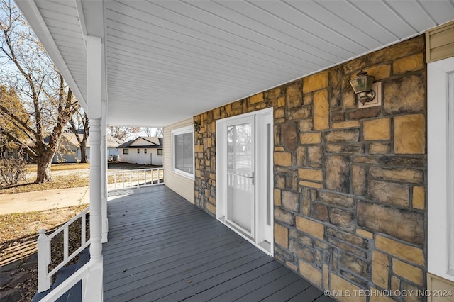 wooden terrace featuring covered porch