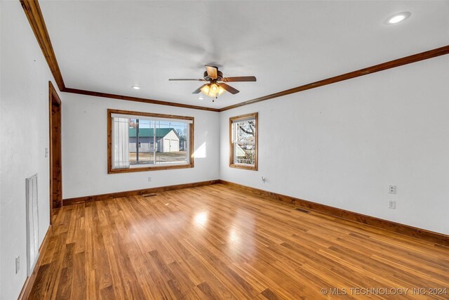 spare room featuring ceiling fan, light hardwood / wood-style floors, and crown molding