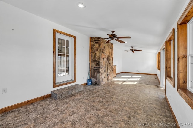 unfurnished living room with ceiling fan