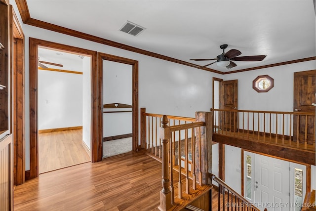 hallway featuring light hardwood / wood-style floors and ornamental molding