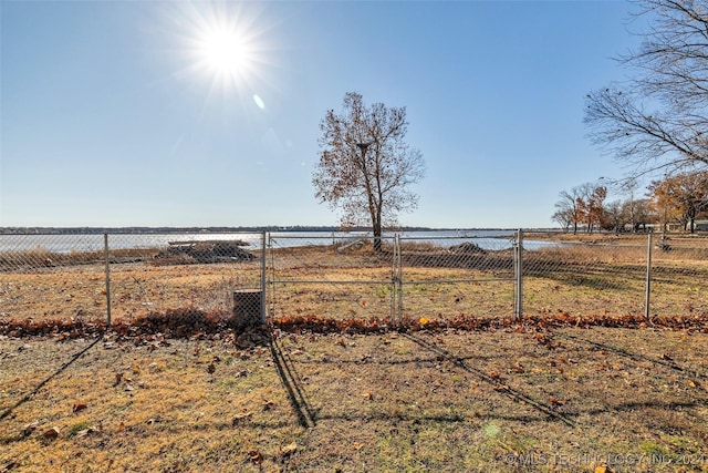 view of yard with a rural view and a water view