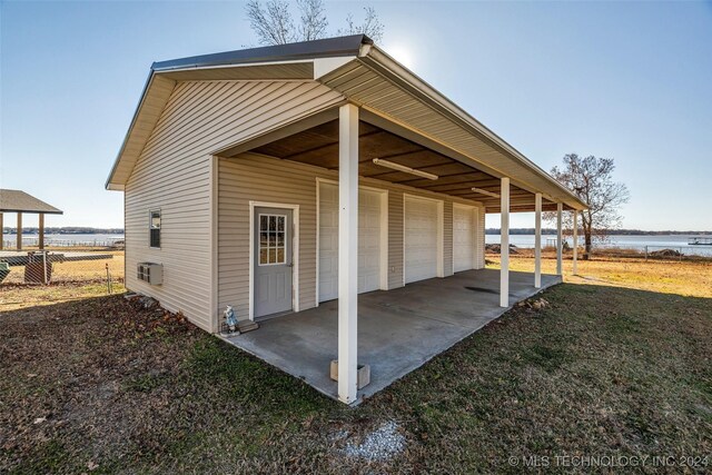 exterior space with a garage and a water view