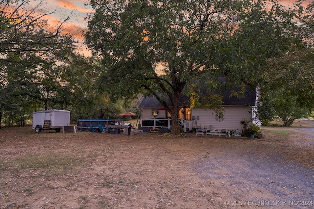 yard at dusk with a storage shed