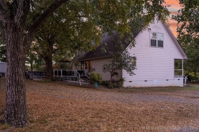 property exterior at dusk with a deck