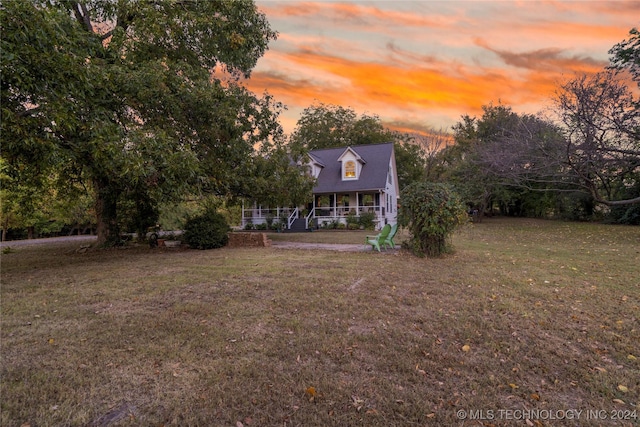 view of front of home with a yard and a porch