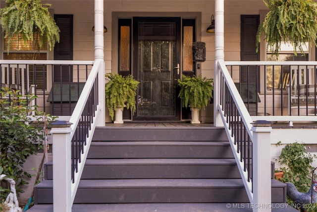 view of exterior entry featuring a porch