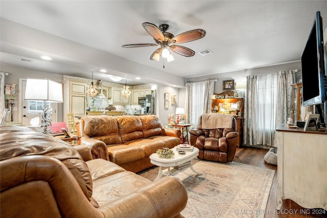 living room featuring ceiling fan and light wood-type flooring