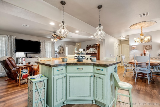 kitchen with wooden counters, a center island, dark wood-type flooring, and green cabinetry