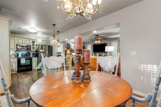 dining space with dark wood-type flooring and ceiling fan with notable chandelier