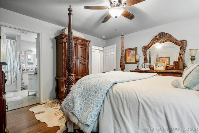 bedroom with hardwood / wood-style flooring, ensuite bath, and ceiling fan