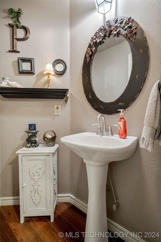 bathroom with hardwood / wood-style floors and sink