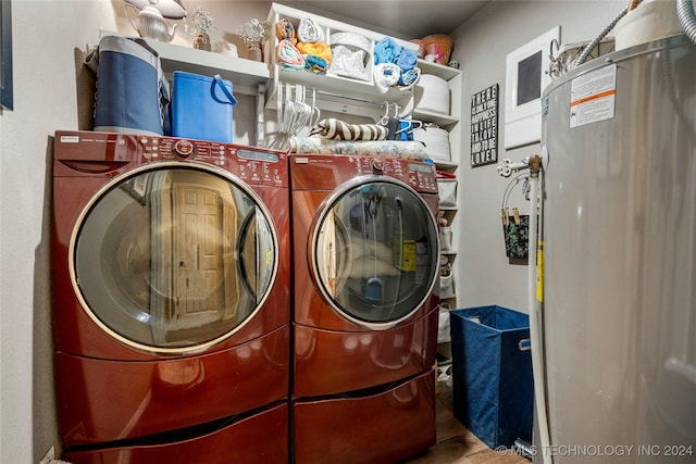 laundry area featuring separate washer and dryer, water heater, and hardwood / wood-style floors