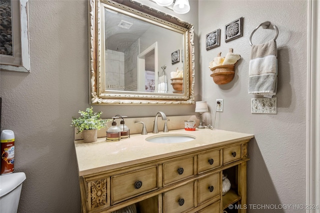 bathroom featuring vanity and toilet