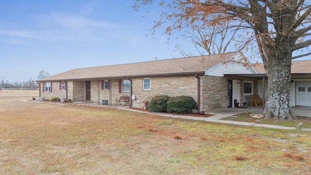 single story home featuring stone siding and a front lawn