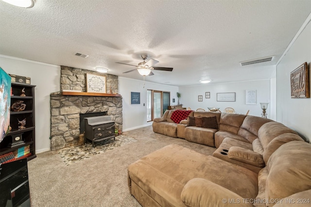 carpeted living area featuring visible vents, a textured ceiling, and ornamental molding