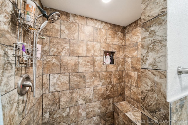 bathroom with tiled shower