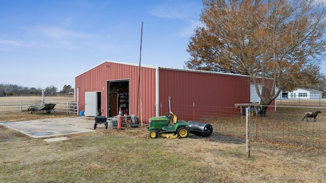 view of pole building with fence