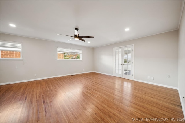 spare room with ceiling fan, french doors, light hardwood / wood-style floors, and ornamental molding