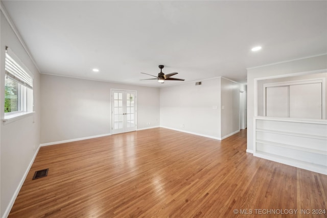 spare room featuring plenty of natural light, ceiling fan, ornamental molding, and light hardwood / wood-style flooring