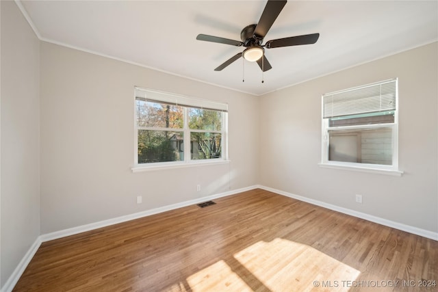 unfurnished room featuring hardwood / wood-style flooring, ceiling fan, and ornamental molding