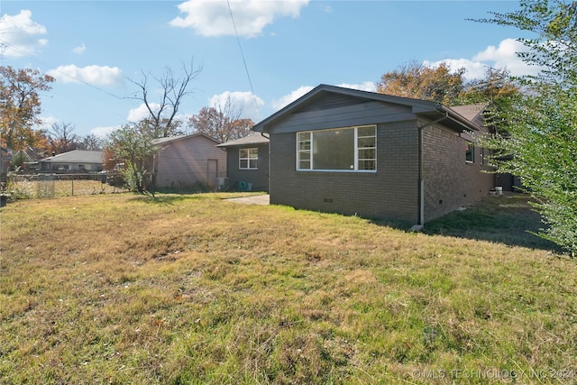 view of property exterior featuring a lawn