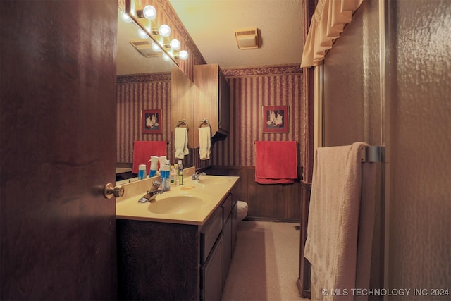 bathroom with a textured ceiling and vanity