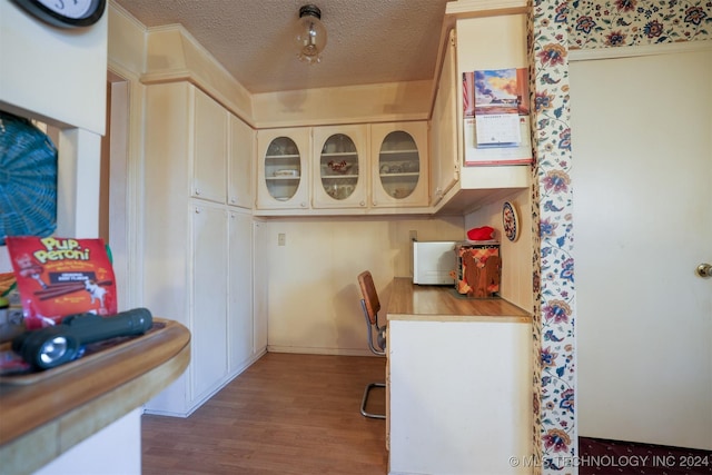 kitchen with wood-type flooring and a textured ceiling