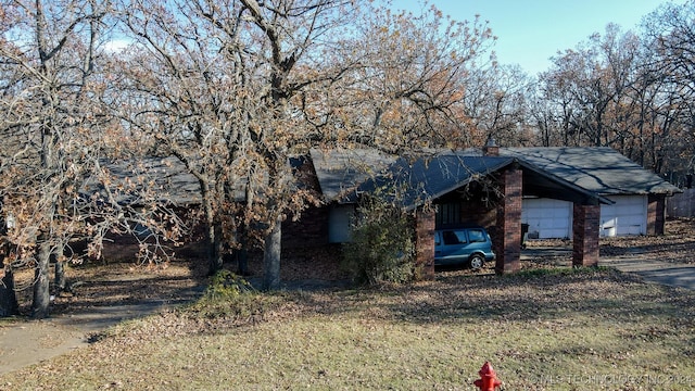 view of front of home with a front yard and a garage