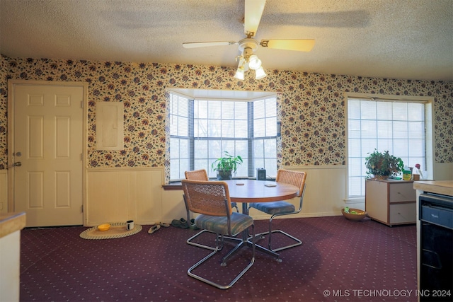 dining area with ceiling fan, wood walls, beverage cooler, and a textured ceiling