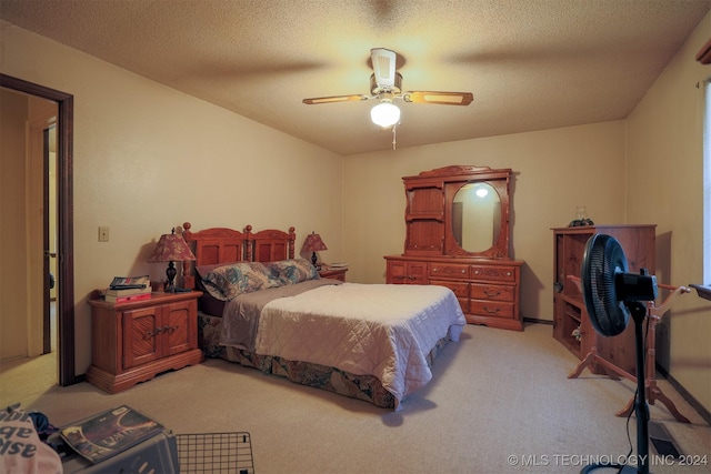 bedroom featuring light carpet, a textured ceiling, and ceiling fan