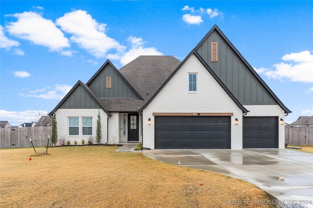 view of front of house with a front yard and a garage