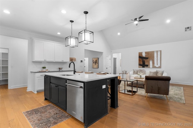 kitchen with sink, hanging light fixtures, stainless steel dishwasher, a kitchen island with sink, and white cabinets