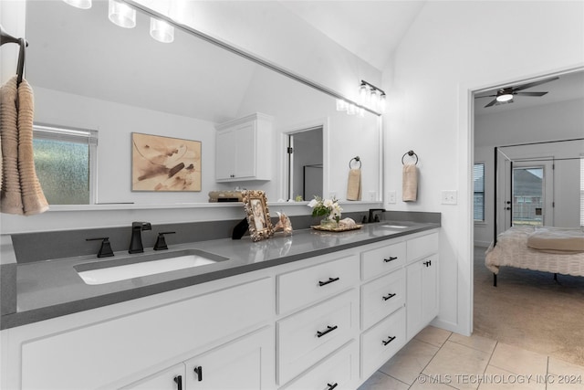 bathroom featuring tile patterned flooring, ceiling fan, vanity, and vaulted ceiling