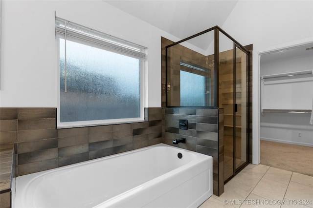 bathroom with tile patterned floors and shower with separate bathtub