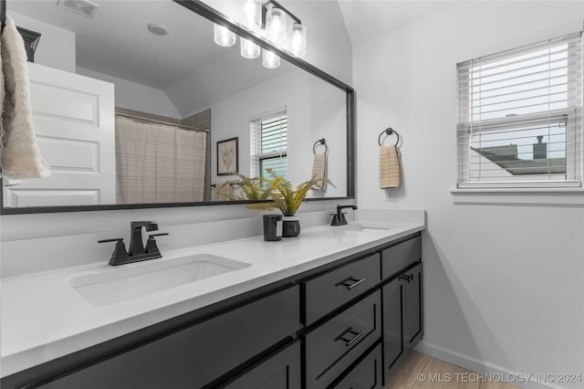 bathroom featuring vanity, lofted ceiling, and a shower with shower curtain