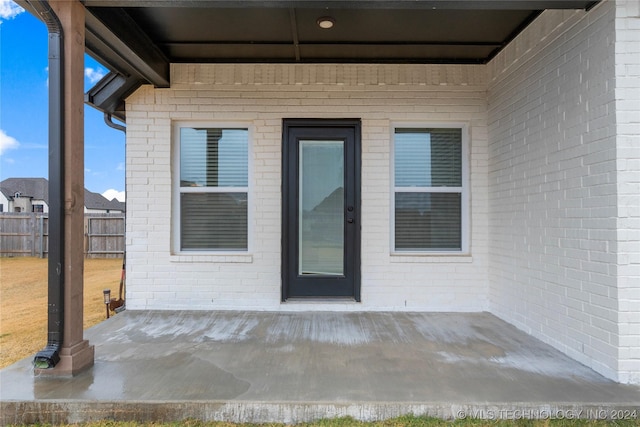 entrance to property featuring a patio