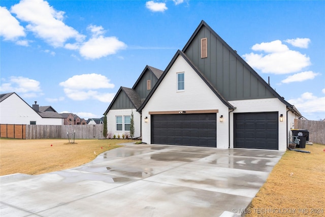 modern farmhouse style home featuring a garage and a front lawn