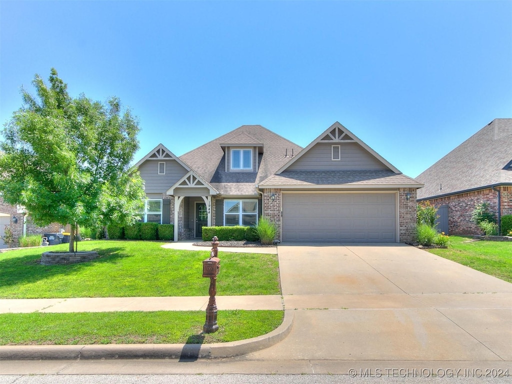 craftsman inspired home featuring a garage and a front lawn