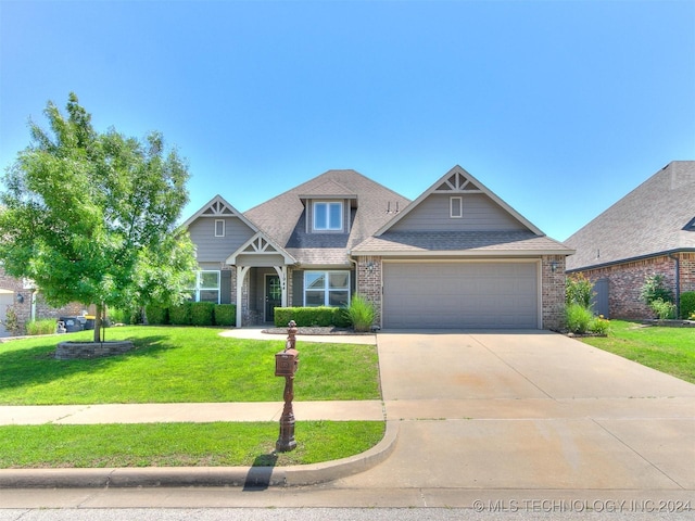 craftsman inspired home featuring a garage and a front lawn