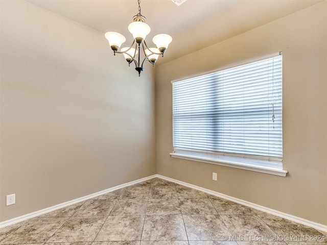 spare room with an inviting chandelier