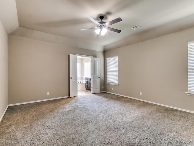 unfurnished bedroom with carpet flooring, ceiling fan, and ensuite bathroom