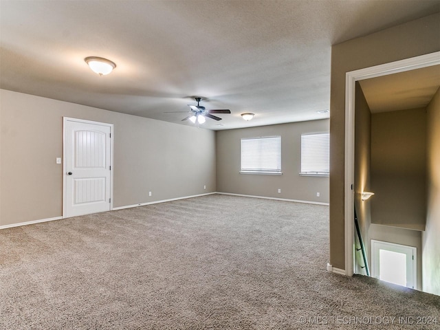 carpeted empty room with ceiling fan